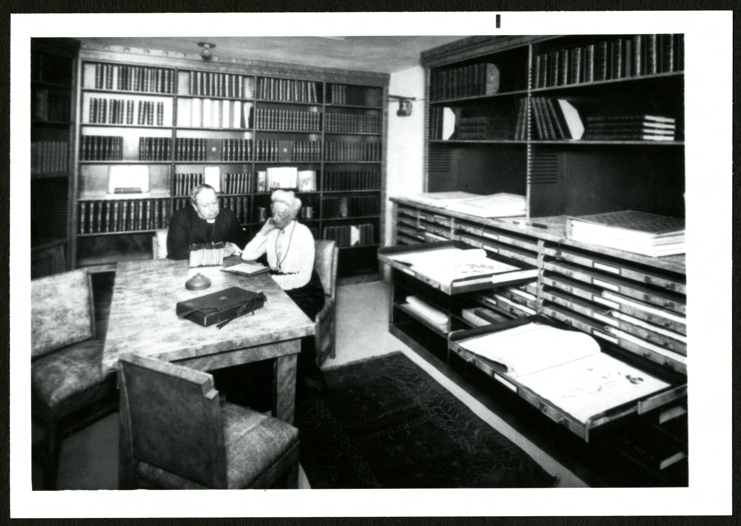 Ellen Browning Scripps sitting in her library with a clergyman